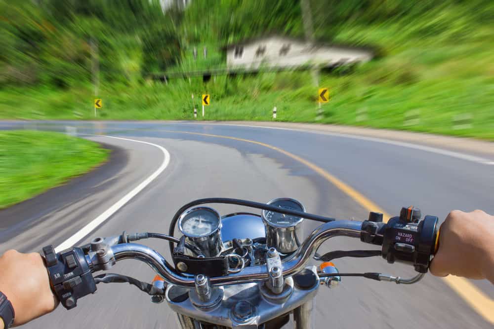 motorcycle-speeding-on-sharp-curve