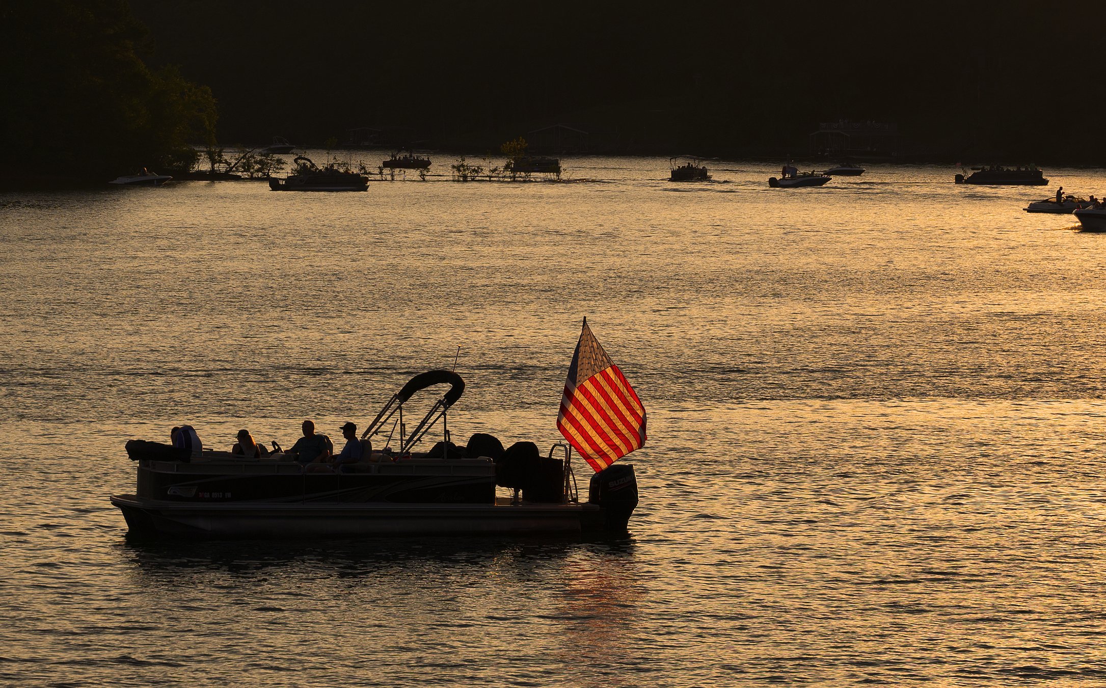 "Boat silhouetted against a beautiful Lake Lanier during summer."