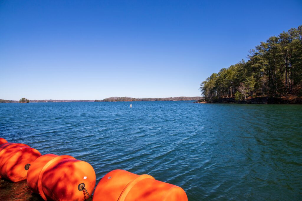 Lake Lanier with orange swim barrier floats in foreground