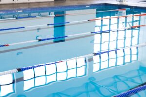 Floating Red, White, And Blue swimming lane dividers in empty indoor poo.