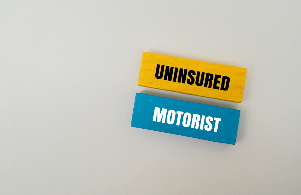 Colorful blocks with text UNINSURED MOTORIST. Concept for auto insurance and risk